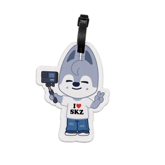 Luggage tag with cartoon character holding a camera, wearing a shirt with 'I ❤️ SKZ' text